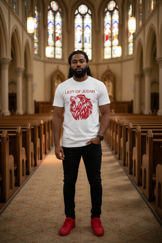 African American man wearing a white short-sleeve t-shirt with bold red graphic of a Lion's head roaring and Bold lettering that reads Lion of Judah above the lions head.